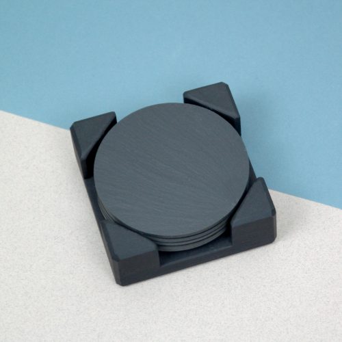 A set of Round Blue Grey Welsh Slate Coasters placed in a slate Coaster Holder
